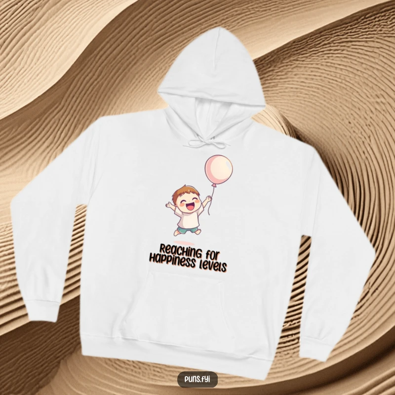 Funny Hoodie displaying a smiling character jumping for joy, reaching for a floating balloon, designed for cozy, happy vibes.
