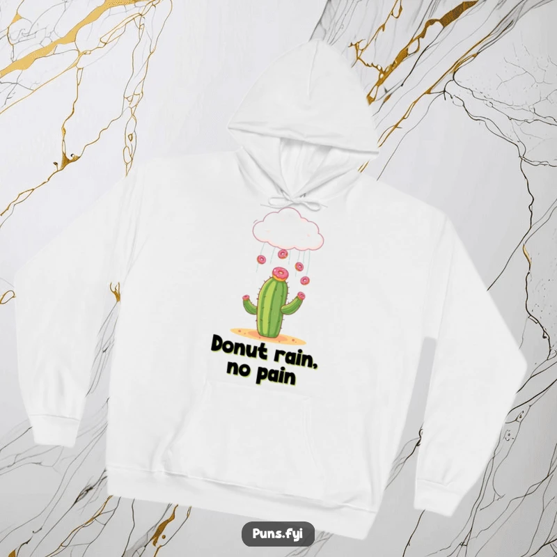Funny hoodie featuring a cloud raining donuts onto a surprised cactus, bringing sweet, comforting humor.